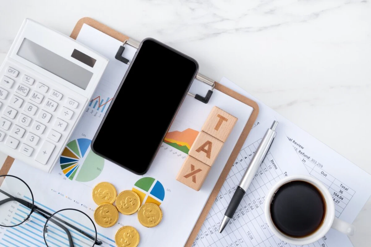 Top view of reading the overview and calculating, paying tax with smart phone from internet.