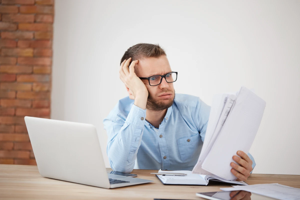 close-up-young-exhausted-unhappy-bearded-male-finance-manager-sitting-office-late-evening