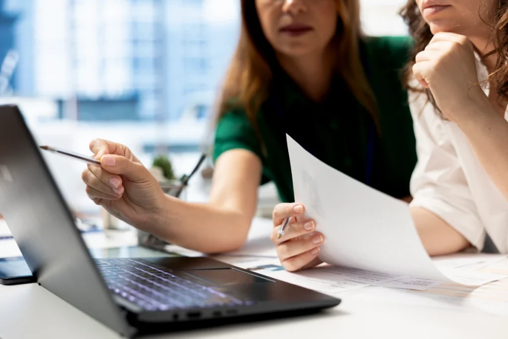 coworkers using laptop to file IRS disaster tax help