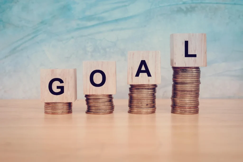 Wooden blocks with 'goal' text on a table, representing the business concept of Planning post-tax season, with copy space